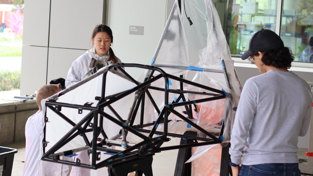 Picture of students standing around chassis