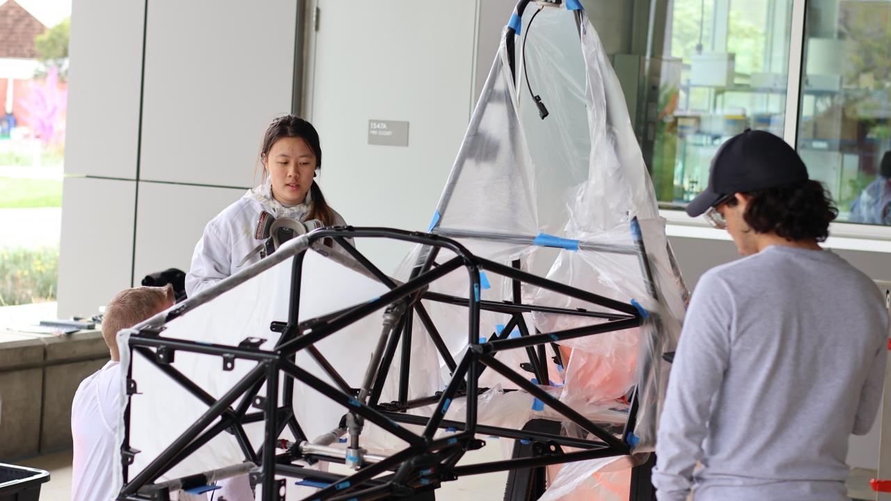 Picture of students standing around chassis