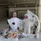 Team members pose while painting