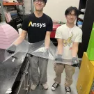 Team members holding up nosecone vacuum seal wrap